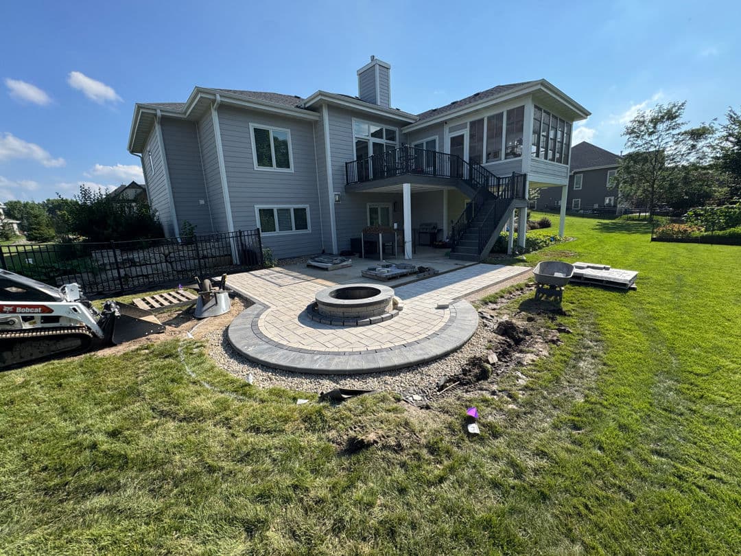 Paver Patio Extension and Fire Pit Built to Handle a Sloped Backyard image